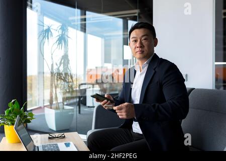 Chinese businessman working in the office shopping in an online store Stock Photo