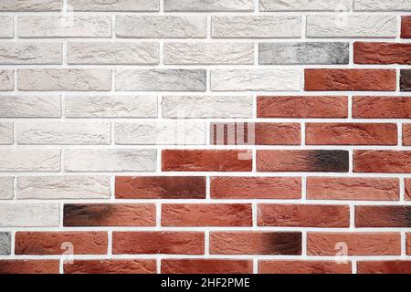 Decorative brickwork background of red and white bricks laid out diagonally. Decorative masonry. Stock Photo