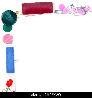 Sewing accessories isolated on white background. Colorful frame of buttons and needles. Free space for text. Stock Photo