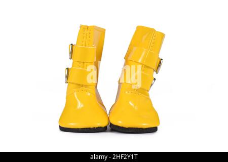 Pair of yellow doll rain rubber boots on white background Stock Photo