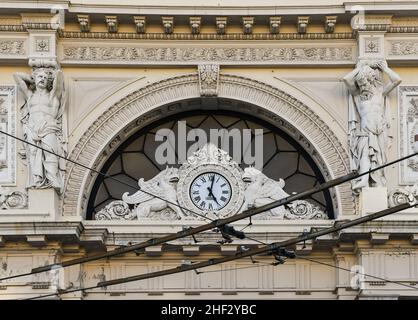 Detail of the façade of Genova Piazza Principe railway station (1860) with a clock guarded by two heraldic griffons and telamons, Genoa, Liguria, Ital