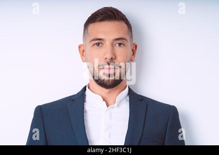 Young handsome man in suit isolated on a white background. Businessman isolated, office people Stock Photo