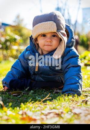 Outdoor portrait of 9 month old boy with Philadelphia; Pennsylvania; skyline beyond Stock Photo