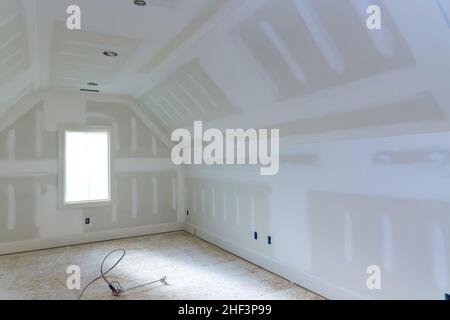 Finishing plastering drywall in ready for paint with new house Stock Photo