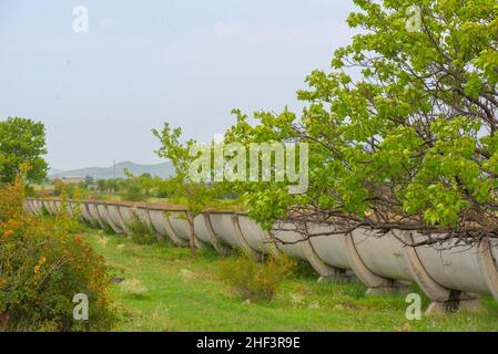 a long water ditch goes through the fields Stock Photo