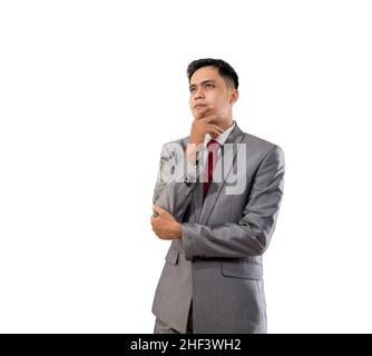 businessman thinking while looking up to copyspace Stock Photo
