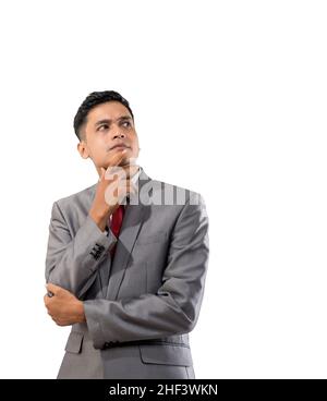 businessman thinking while looking up to copyspace Stock Photo