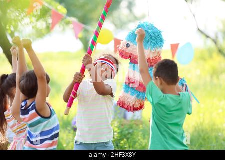 Cute children at pinata birthday party Stock Photo