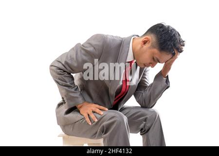businessman in his suit feeling stressed hold his head Stock Photo