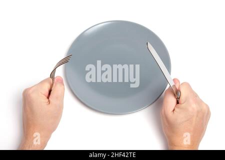 Empty plate and hands with cutlery spoon and fork white background Stock Photo
