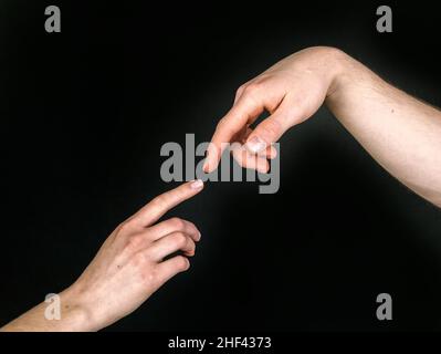 Fingers of Two People Nearly Touching - Isolated Stock Photo