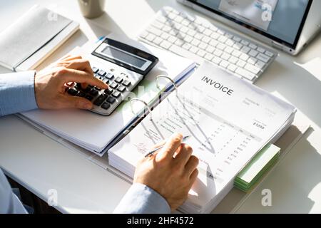 Public Tax Accountant Using Calculator. Finance Ledger Stock Photo