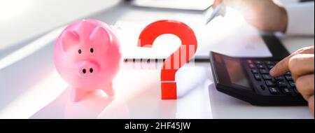 Question Mark Next To Piggy Bank. Money Saving And Investment Strategies Concept Stock Photo