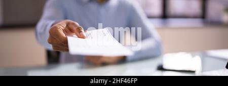 African Business Man Giving Paycheck Or Payroll Cheque Stock Photo