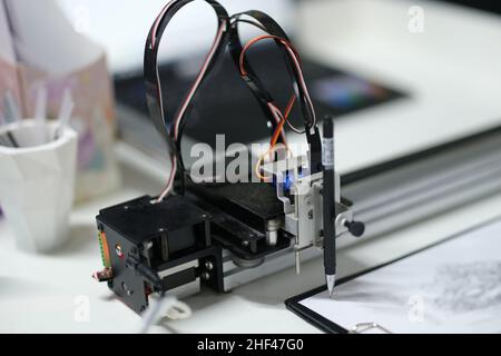 3d printer draws with a pencil on paper, blurry Stock Photo
