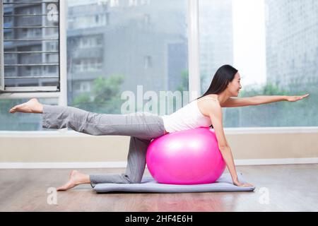 Young woman resting against the fitness ball Stock Photo