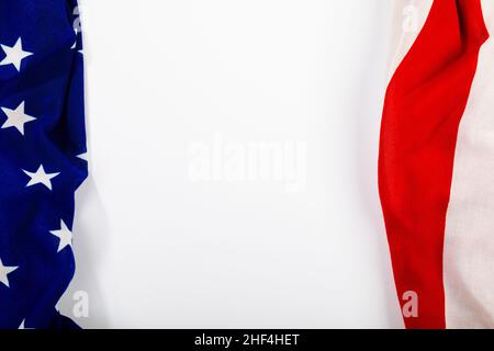 Stars on blue fabric near red stripes making them america flag on white background with copy space Stock Photo