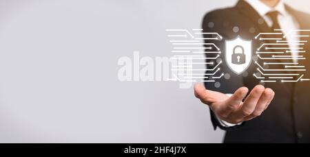 Protection network security computer and safe your data concept, Businessman holding shield protect icon. lock symbol, concept about security, cyberse Stock Photo