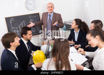 Team of adult engineers discussing new project Stock Photo