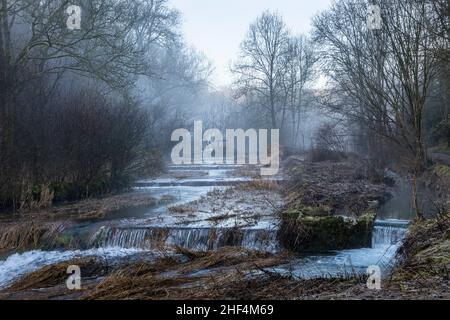 The River Lathkill on a misty winter morning, Lathkill Dale, Peak District National Park, Derbyshire, England Stock Photo
