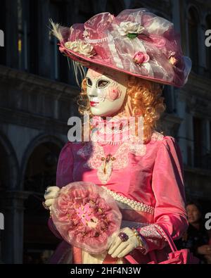 Portrait of woman in pretty pink rococo Venetian historic fancy dress costume, Carnevale di Venezia, Venice Carnival, Italy Stock Photo