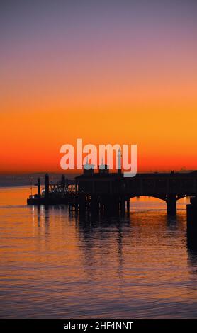 14/01/2022 Gravesend UK Dawn on the River Thames. Jacob Marley the Gravesend to Tilbury ferry is crossing the river while ro-ro cargo ship Pauline hea Stock Photo