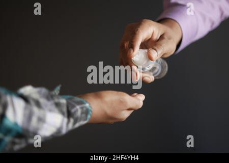 two people using sanitizer gel for preventing virus. Stock Photo