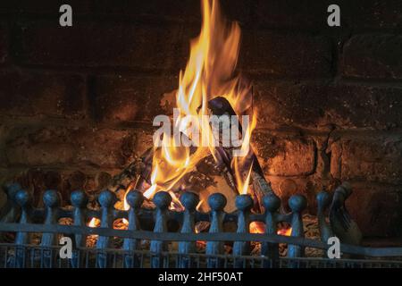 Wood fire blazing in a an open grate. Stock Photo