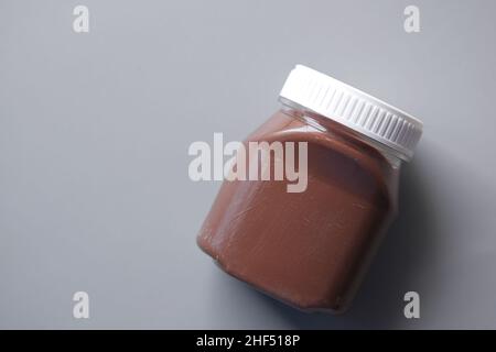 Chocolate Hazelnut cream in a container on black background  Stock Photo