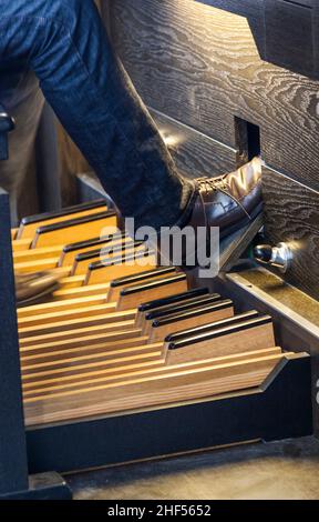 feed using the pedals at the church organ Stock Photo