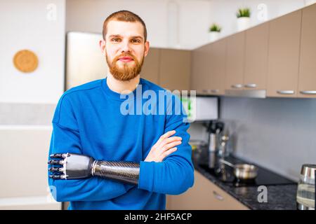 young man with modern biotechnology hand in apartment Stock Photo