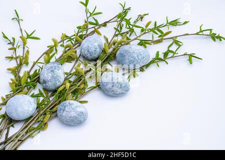 Marble Easter eggs and willow twigs on a white background. Easter greeting card. Horizontal photo. Stock Photo