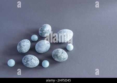 Top view of marble colored Easter eggs on a gray background. Easter background. Horizontal photo. Stock Photo
