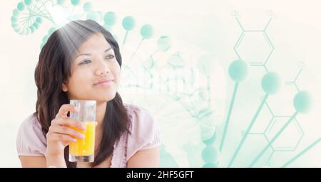 Composite image of asian woman with a juice glass against dna structure with copy space Stock Photo