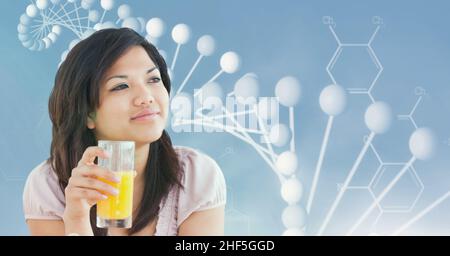 Composite image of asian woman with a juice glass against dna structure with copy space Stock Photo