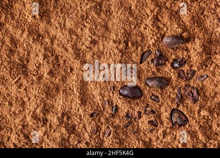 Cocoa powder background with cacao beans Stock Photo