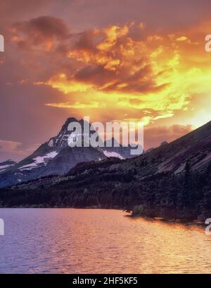 Sunset on Swiftcurrent Lake with Mount Wilbur. Glacier National Park, Montana. Stock Photo