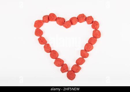 Heart made with candy on white background Stock Photo