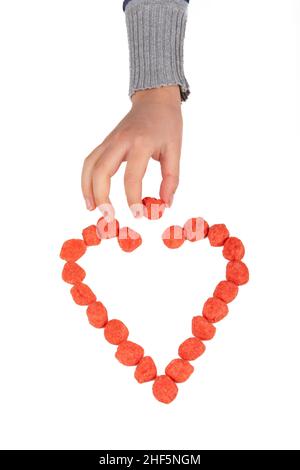 Heart made with candy on white background Stock Photo