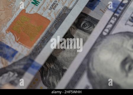 Benjamin Franklin peeking through 100 dollar banknotes for design purpose Stock Photo