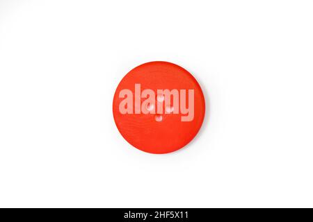 A red button isolated on a white background in a close up view Stock Photo