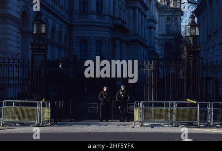 London, UK. 14th Jan, 2022. Armed police officers outside the Downing Street gates. The Metropolitan Police says it won't look into the parties which took place at 10 Downing Street during the coronavirus lockdown, unless there is evidence of criminality. Credit: Vuk Valcic/Alamy Live News Stock Photo