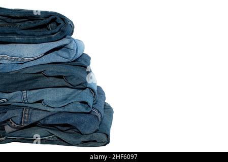 A stack of jeans in different colors on a white background. Jeans isolate with place for inscription Stock Photo