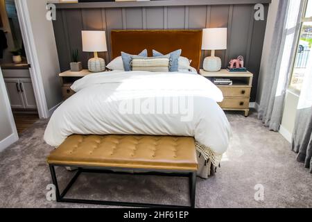 Padded Foot Stand At End Of Bed In Master Bedroom Stock Photo