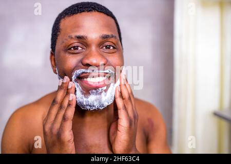 hispanic man put on foam on beard perfume lotion or skin care cream for sensitive skin Stock Photo