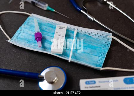 A rapid antigen test for SARS-CoV-2 or Covid is seen on a table with nasal swab stick during a rapid surge in demand due to the Omicron variant of Cov Stock Photo