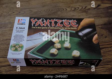 Yahtzee is a fun game for all the family. A dice game made by Milton Bradley (now owned by Hasbro), players roll the dice three times and log scores o Stock Photo