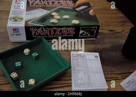 Yahtzee is a fun game for all the family. A dice game made by Milton Bradley (now owned by Hasbro), players roll the dice three times and log scores o Stock Photo