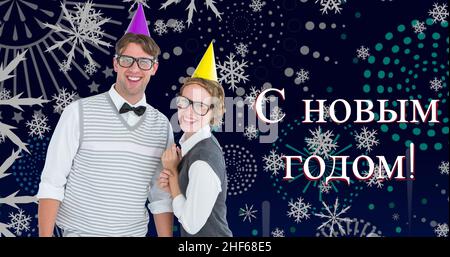 Caucasian couple with party hats celebrating russian orthodox new year on snowflake background Stock Photo