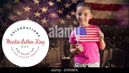 Portrait of smiling caucasian girl holding america flag by martin luther king jr day Stock Photo